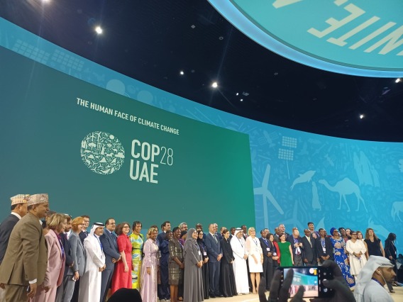 Group of people standing on a stage at COP28 in Dubai