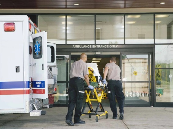 EMTs with a patient heading into a hospital.