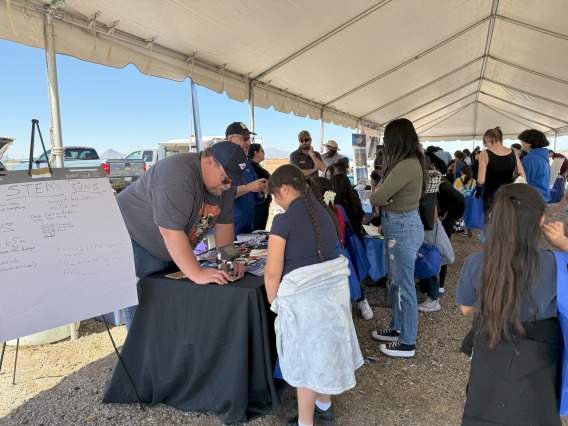 Youth DMAFB STEAM Village student attendees visiting the AZ Science Center/InSimEd table.