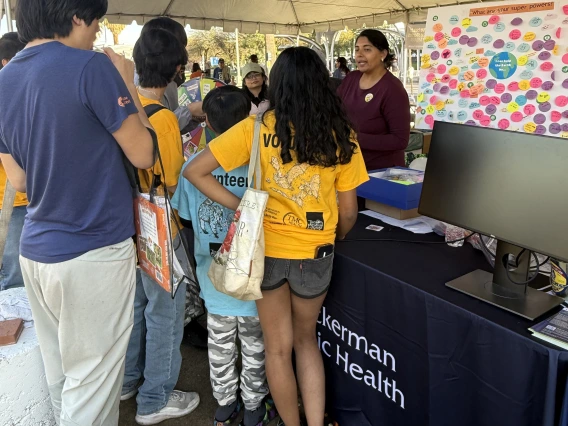 Dr. Mona Arora engaging participants in the spin-the-wheel climate and health trivia game.
