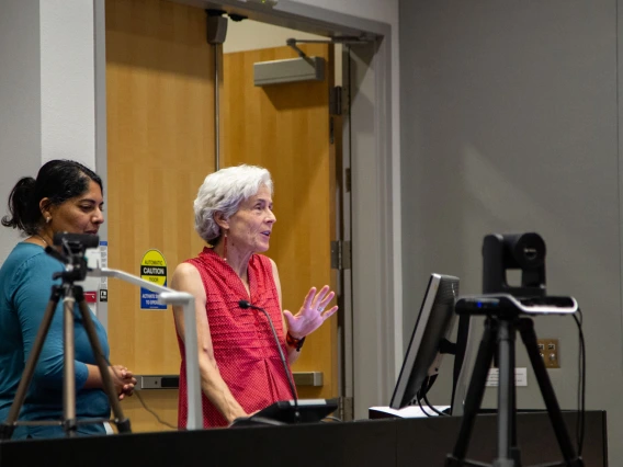 Image of Mona Arora and Maia Ingram introduce the Mentimeter poll to the audience.