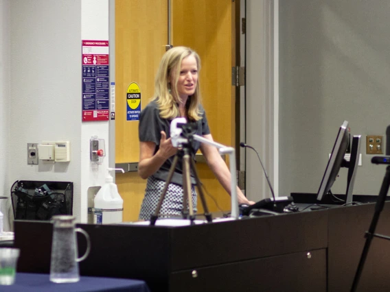Image of Kate Ellingson (MEZCOPH) describing her farm worker enumeration work.