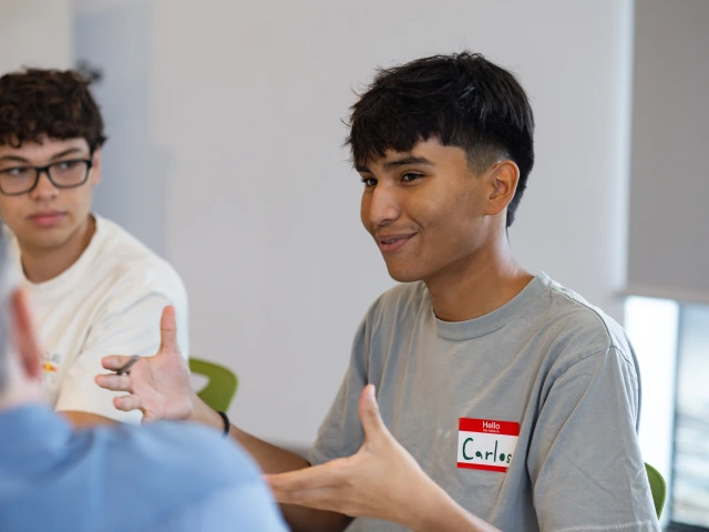 Two young men engaged in a discussion.