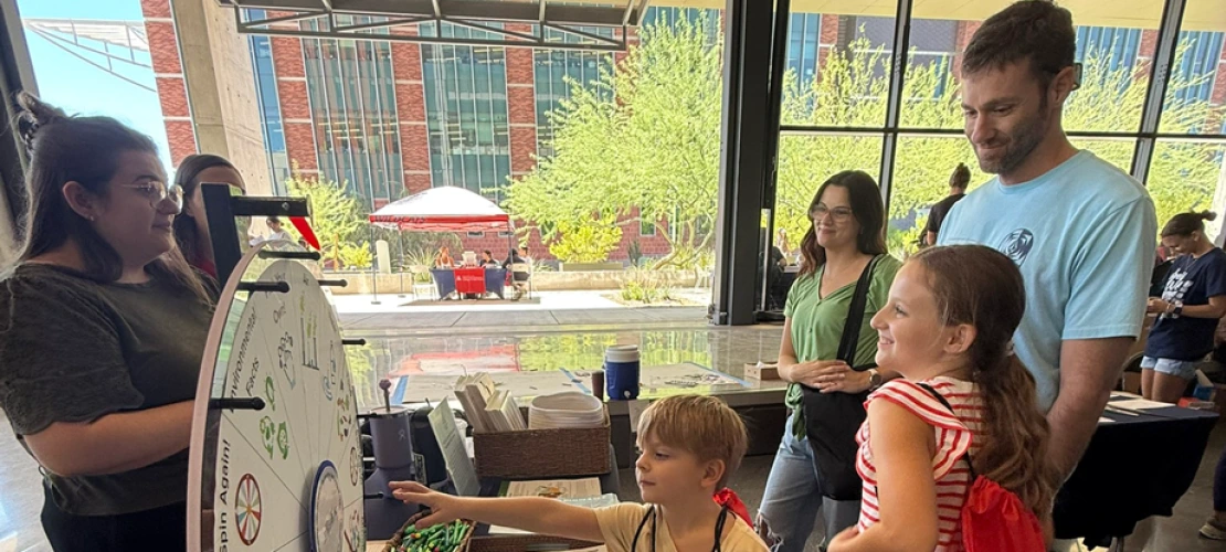 MEZCOPH's Abbie Austin with family (mom, dad, son, and daughter) at the SCORCH 'Connect 2 STEM' table.