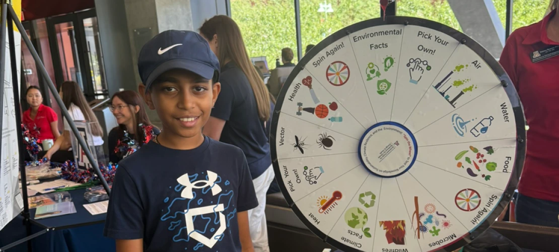 Young man at the 'Wellness & Wonder - Connect 2 STEM' table.