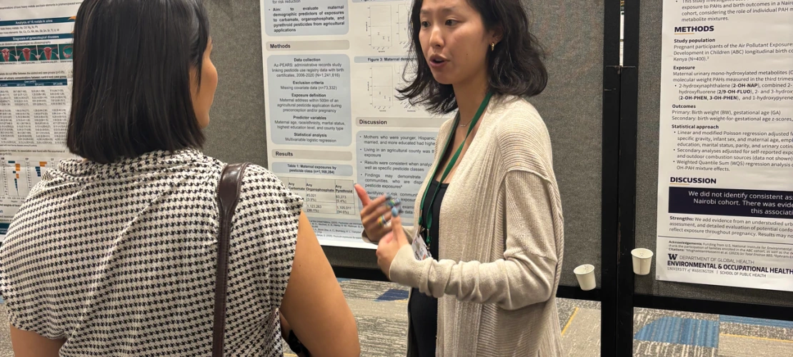 Audrey Yang discusses her research with an attenddee at a 2025 ISES/ISEE Conference poster presentation.