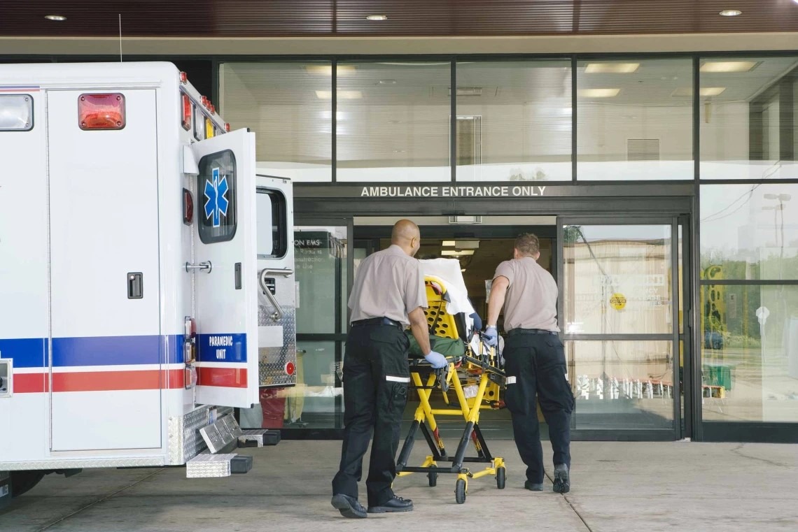 EMTs with a patient heading into a hospital.