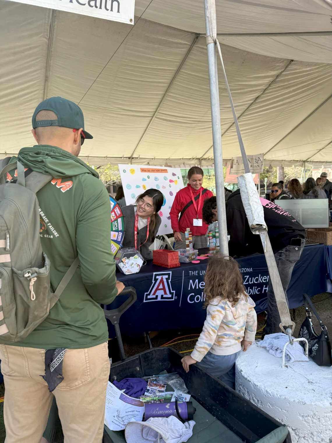 A family engaged in the spin-the-wheel climate and health trivia game.