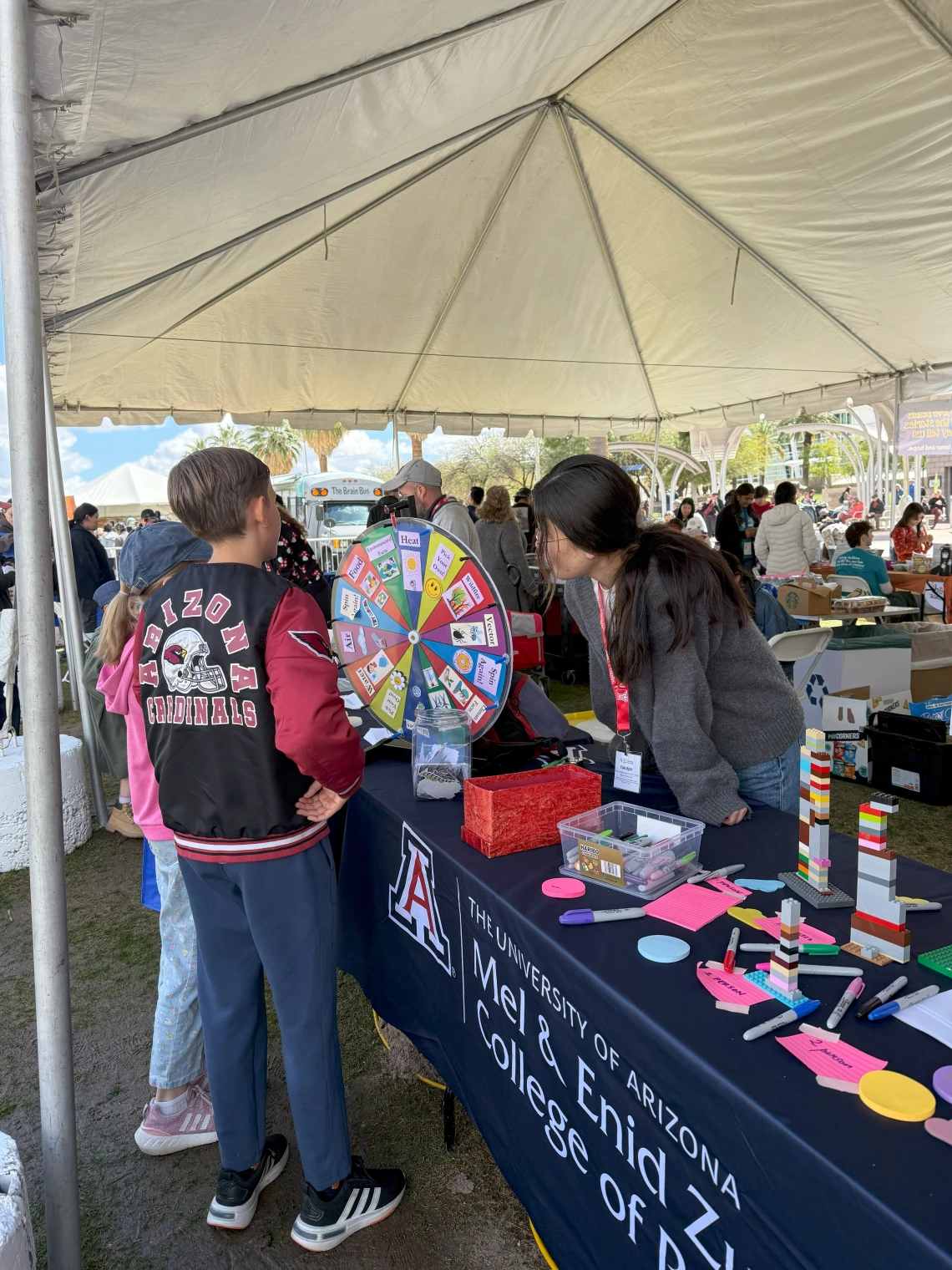 Festival goers playing a climate and health spin-the-wheel trivia game.