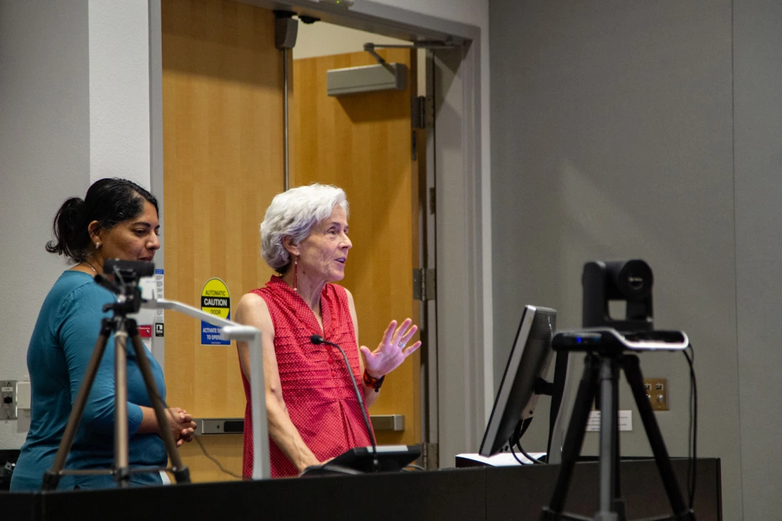 Image of Mona Arora and Maia Ingram introduce the Mentimeter poll to the audience.