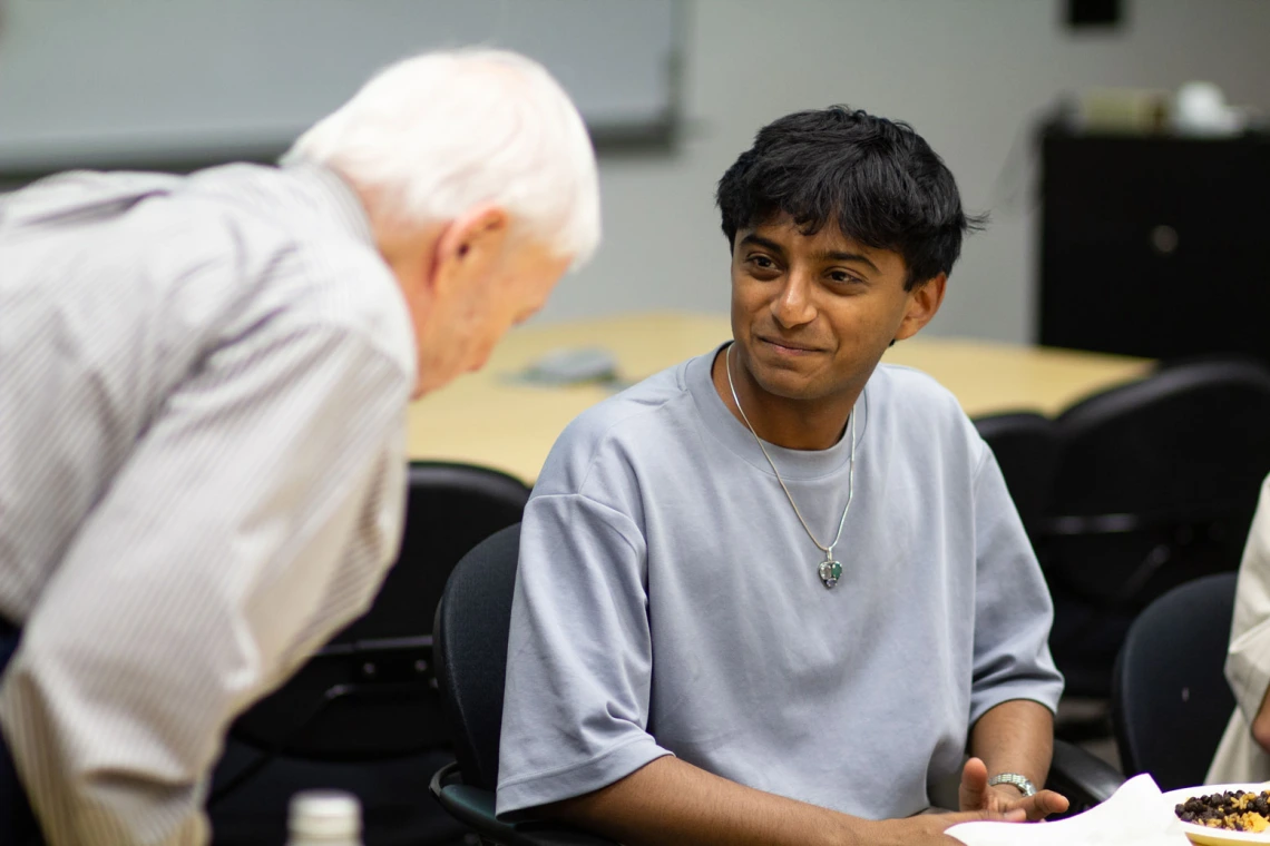 Image of Mark Ginsberg and Ojas Sanghi talking.