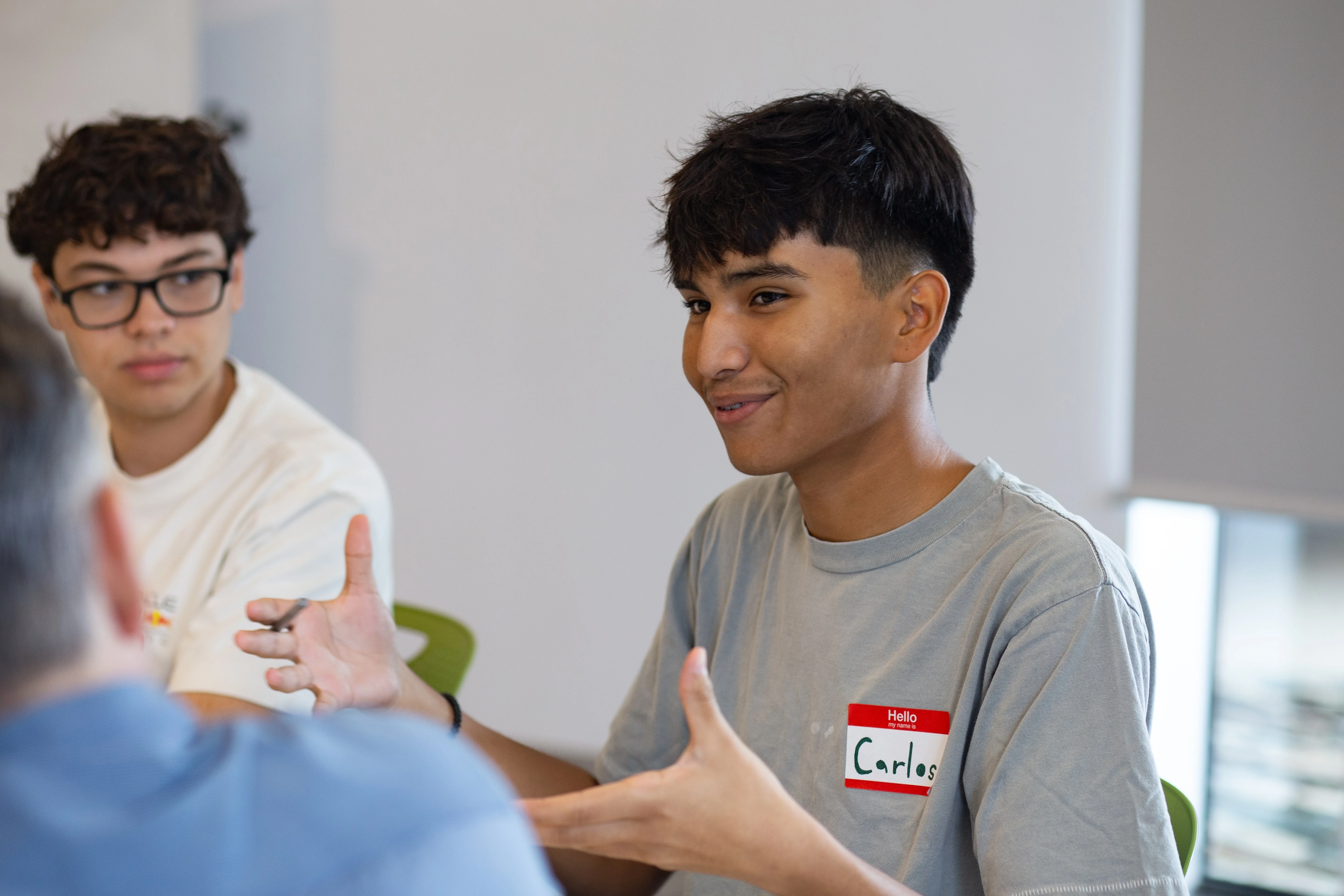 Two young men engaged in a discussion.