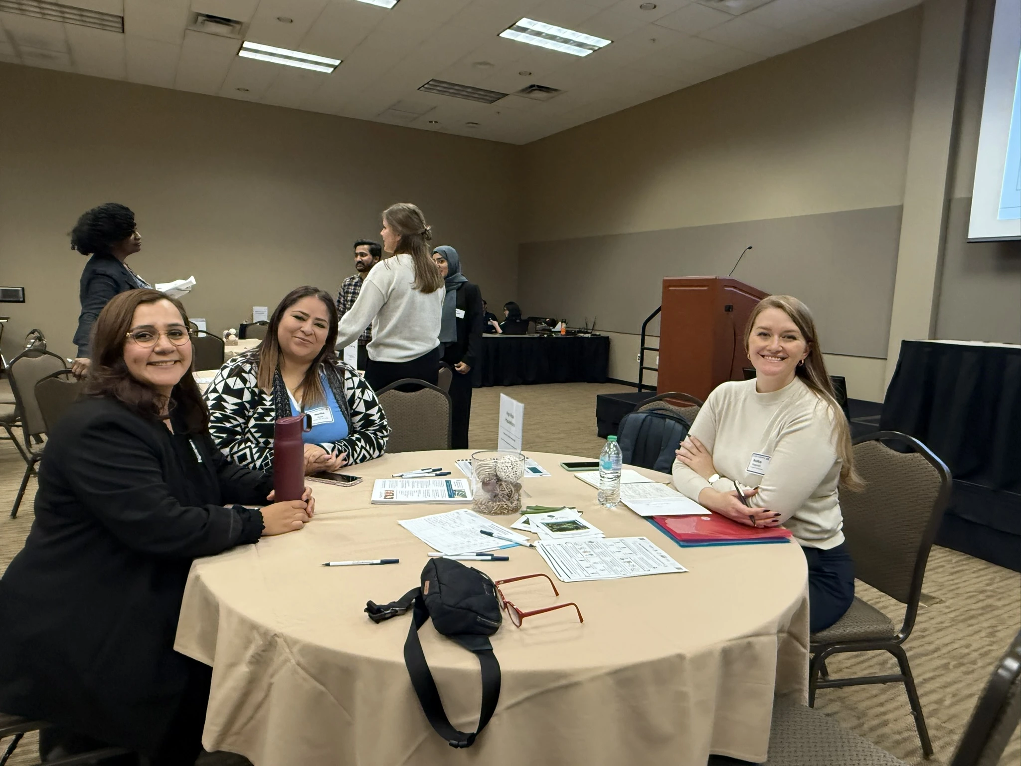 Photo of Martha Reyes, Karina Martinez Molina, and Rietta Wagoner at a table.