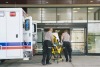 EMTs with a patient heading into a hospital.